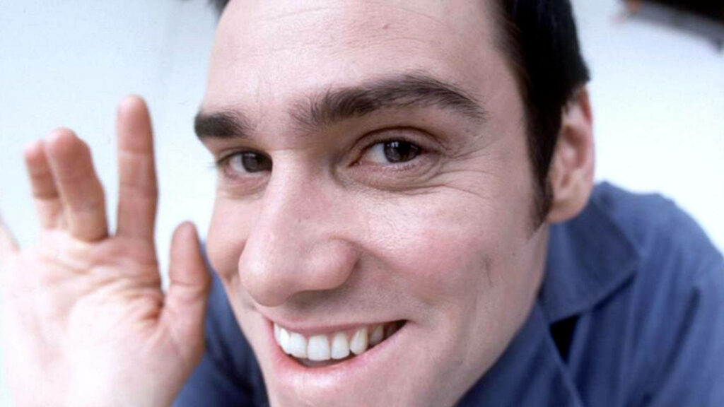 Jim Carrey smiling and waving close up vibrant wallpaper capturing playful energetic personality