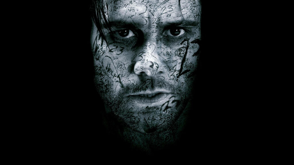Jim Carrey intense face with detailed number and symbol tattoos dark dramatic wallpaper background