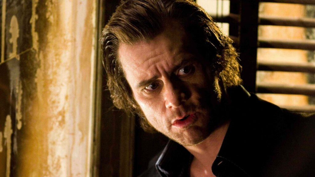 Jim Carrey tense nervous expression in dimly lit room dramatic suspenseful wallpaper background