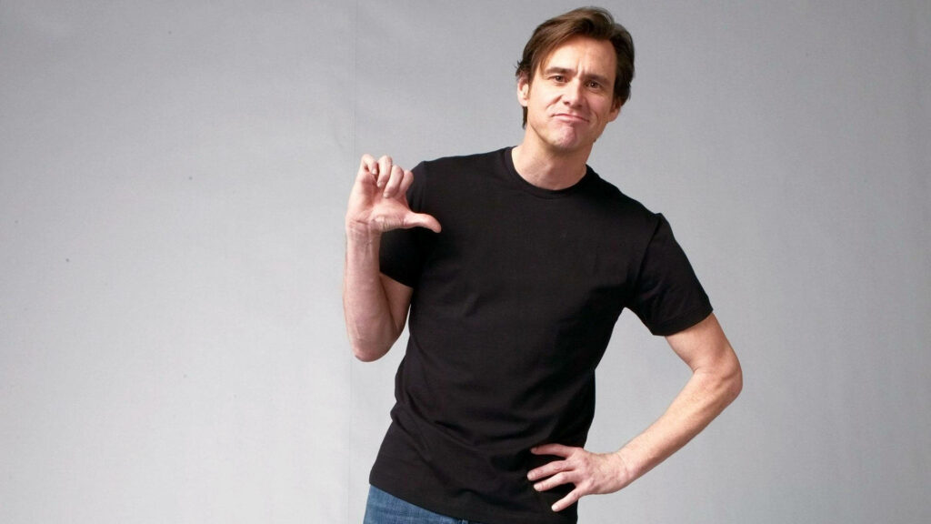 Jim Carrey smiling with thumbs down playful gesture fun lighthearted personality wallpaper background