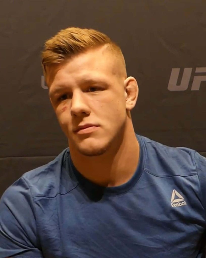 Jimmy Crute UFC fighter intense portrait in blue Reebok shirt dark MMA sports wallpaper background