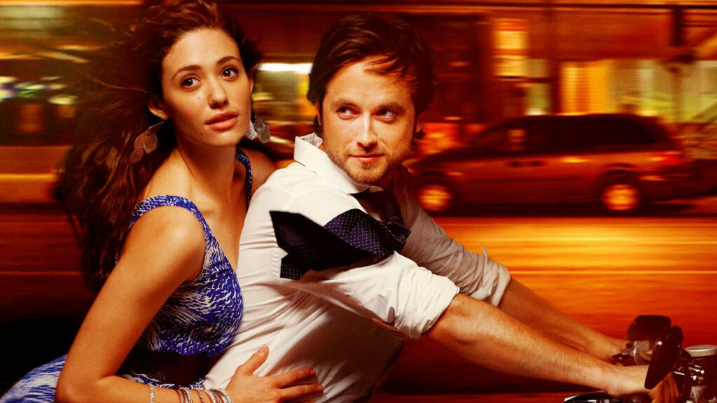 Jimmy and Fiona from Shameless riding motorcycle at night with blurred city lights background Wallpaper