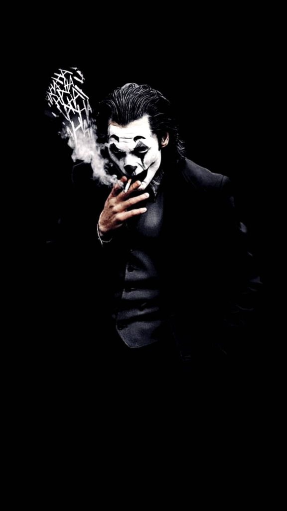 Joker wallpaper featuring Joaquin Phoenix smoking with HA patterns on deep black background phone art
