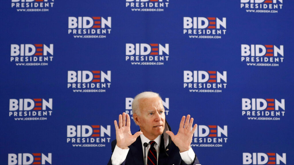 Joe Biden Inspires: Speech Wallpaper with Campaign Signs Background