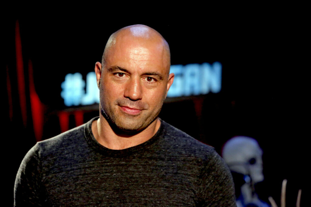 Joe Rogan in Halloween studio set with skeleton decoration spooky festive podcast background Wallpaper