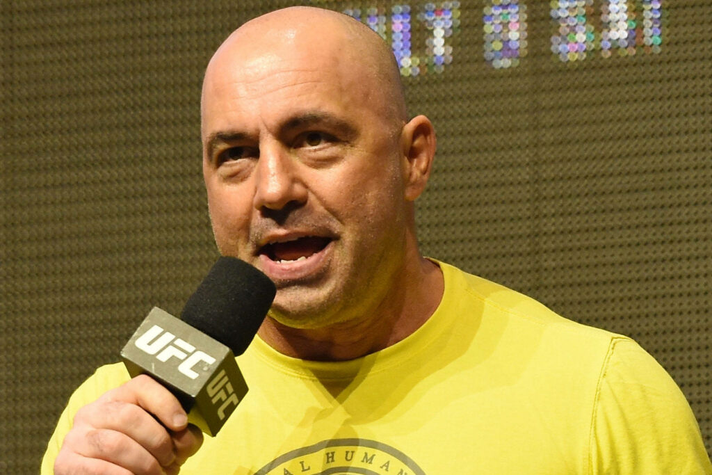 Joe Rogan hosting UFC official weigh-in speaking into UFC microphone intense moment wallpaper