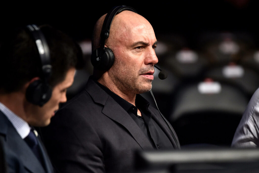 Joe Rogan focused ringside commentary capturing intense UFC event energy and excitement wallpaper