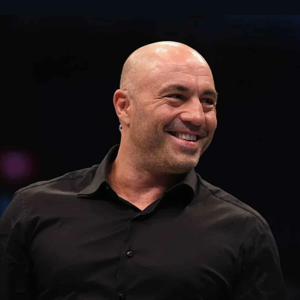 Joe Rogan laughing vibrantly wallpaper capturing his humor and charismatic energy background