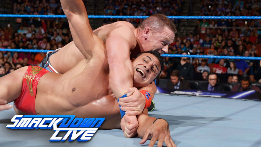 John Cena applies submission lock on Alberto Del Rio in intense SmackDown Live wrestling match background Wallpaper