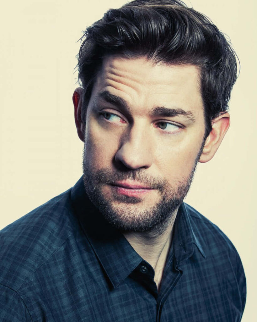 Portrait of Hollywood actor John Krasinski with expressive gaze on soft neutral wallpaper background