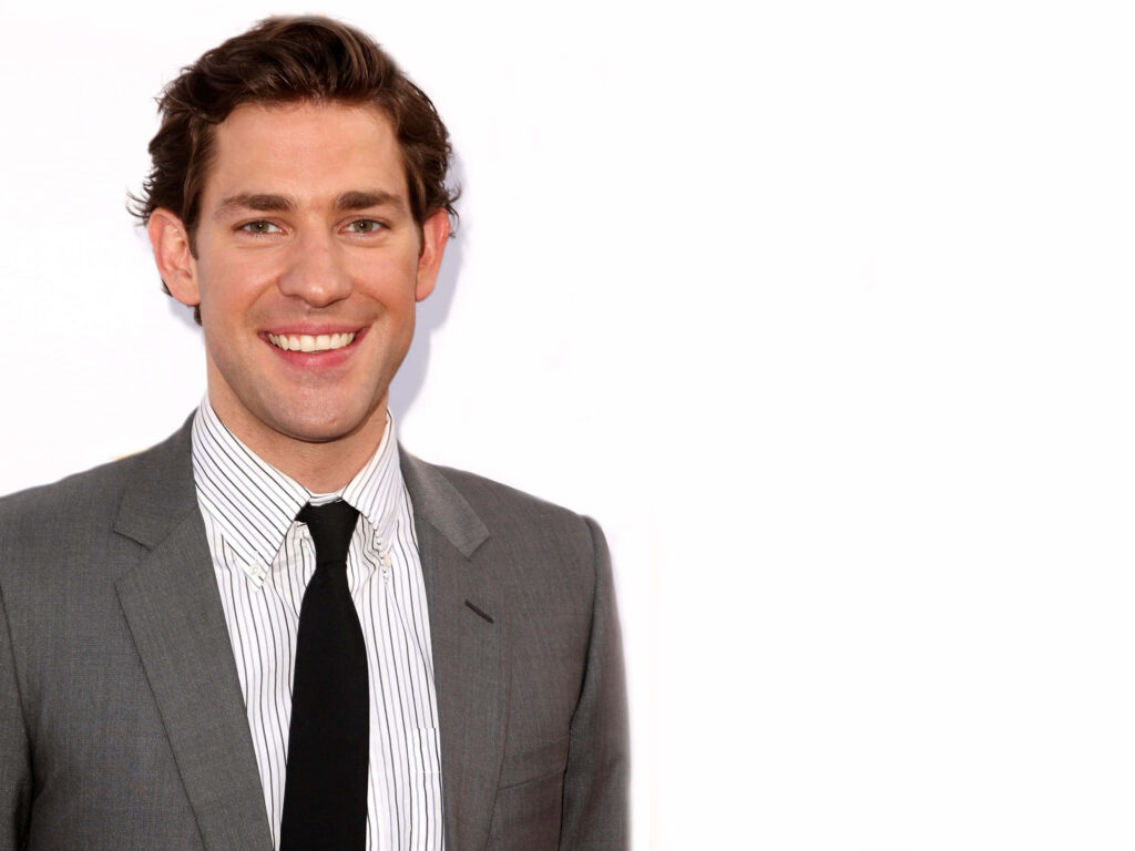 John Krasinski in sharp suit smiling confidently on clean white background friendly charismatic Wallpaper