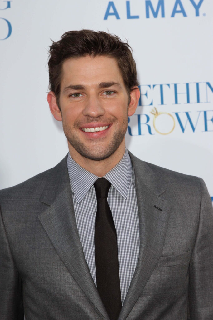 John Krasinski smiling in sharp grey suit friendly professional wallpaper background image
