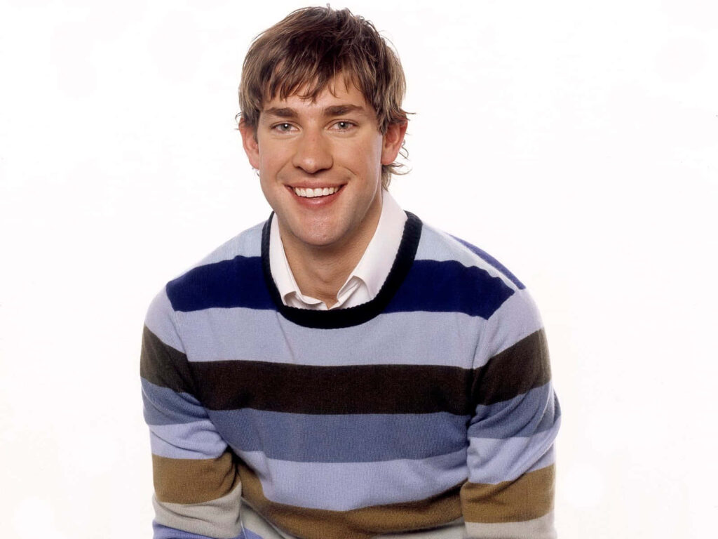 John Krasinski smiling in striped sweater as Jim Halpert from The Office vibrant wallpaper background