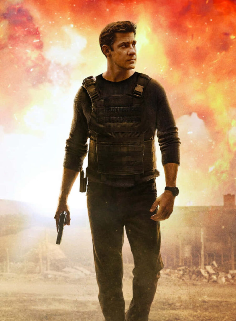 John Krasinski in tactical gear holding gun with fiery explosion intense action scene wallpaper