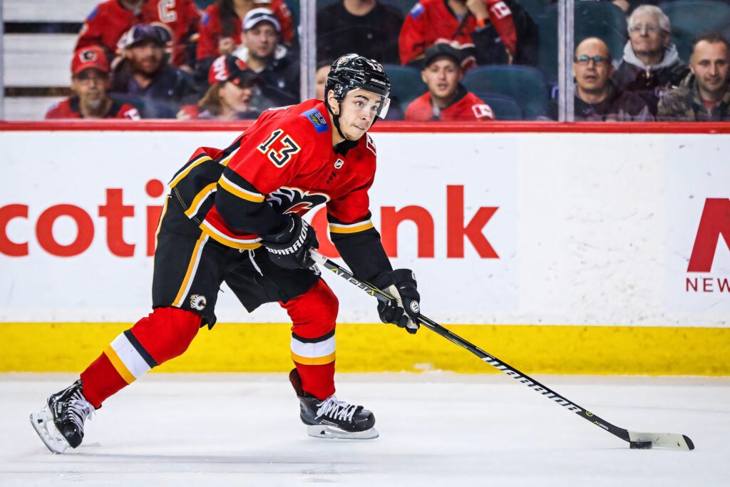 Johnny Gaudreau skating intensely in Calgary Flames jersey during live ice hockey game action Wallpaper