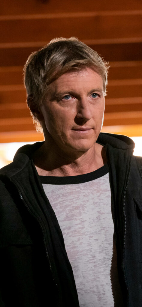 Johnny Lawrence Cobra Kai Wallpaper: Intense & Warm-Toned Background