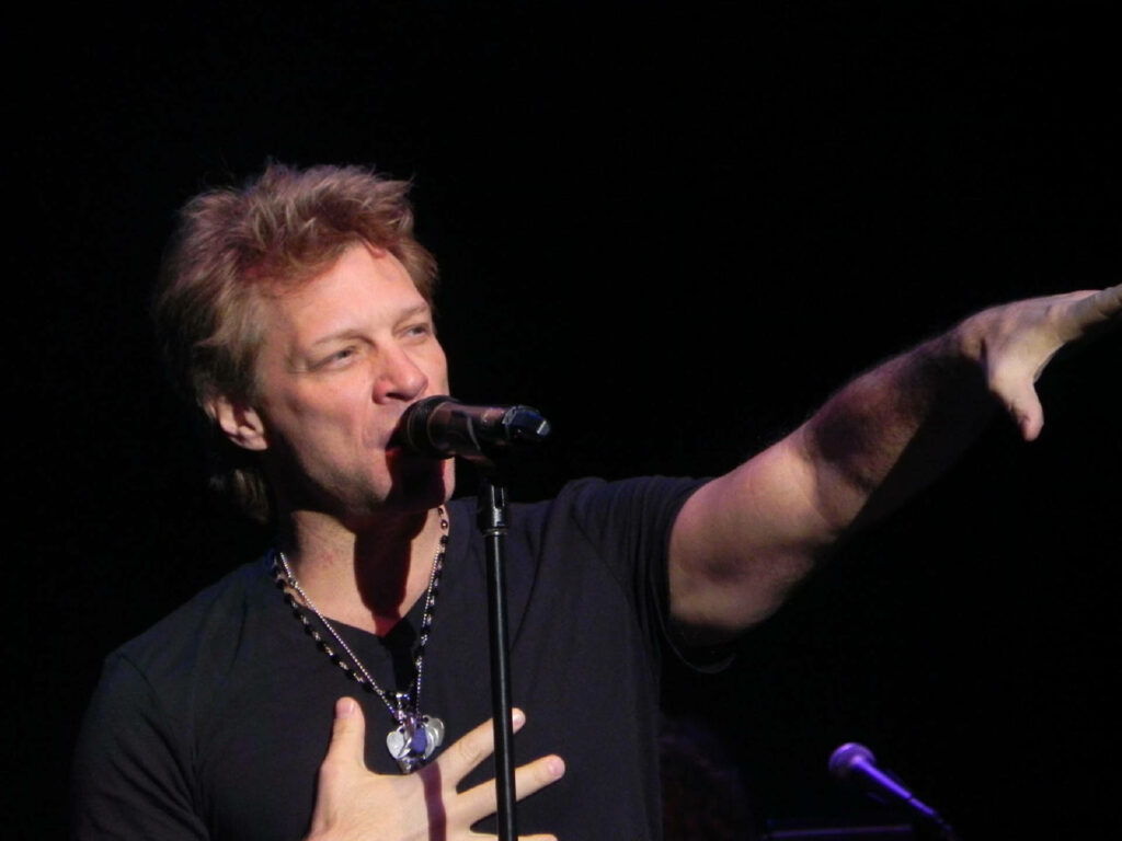 Jon Bon Jovi performing live on stage in Denver 2013 showcasing energy and signature style Wallpaper