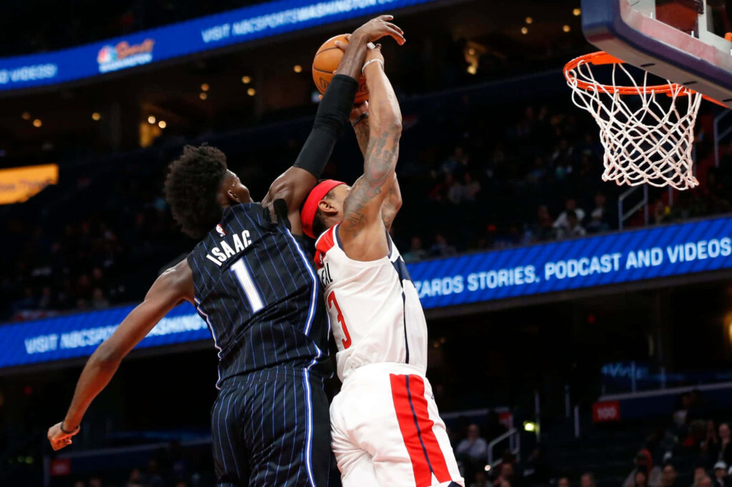 Jonathan Isaac in Orlando Magic jersey jumps to block Detroit Pistons shot in NBA game Wallpaper