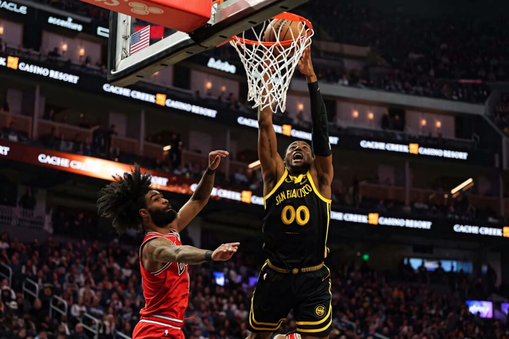 Jonathan Kuminga dunks for Golden State Warriors against Coby White Chicago Bulls in NBA game Wallpaper