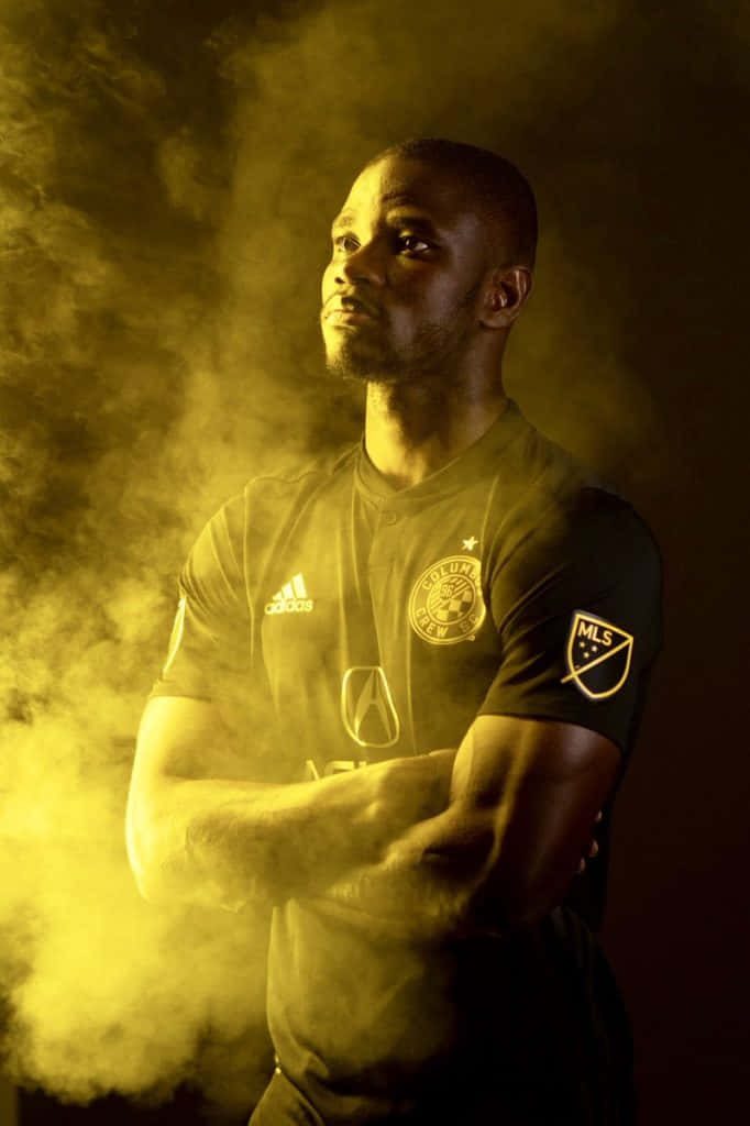 Jonathan Mensah Columbus Crew SC jersey dramatic golden smoke cinematic football wallpaper background