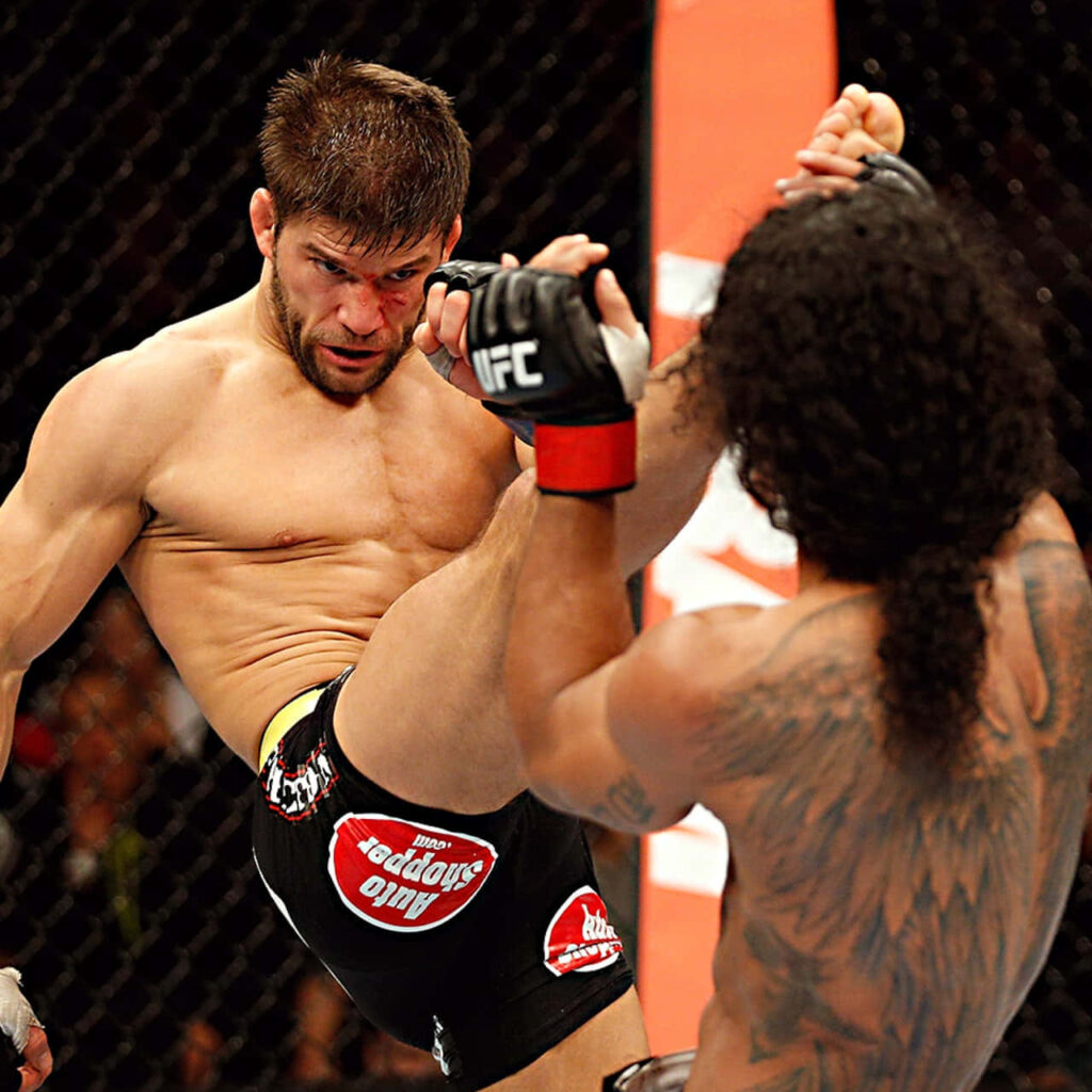 Josh Thomson lands a strong kick on Benson Henderson in a dynamic UFC fight wallpaper background