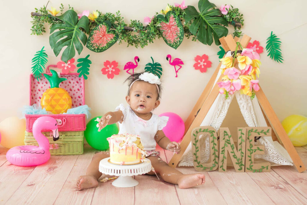 Joyful Baby Cake Smash: Tropical-Themed Birthday Celebration Scene Wallpaper