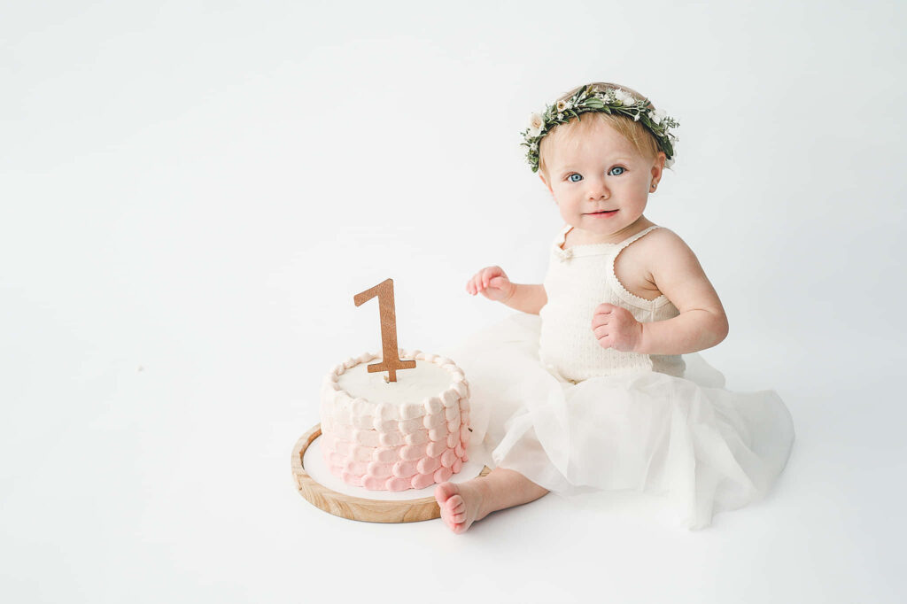 Joyful Cake Smash: Young Child with Festive Decor and Cake Wallpaper