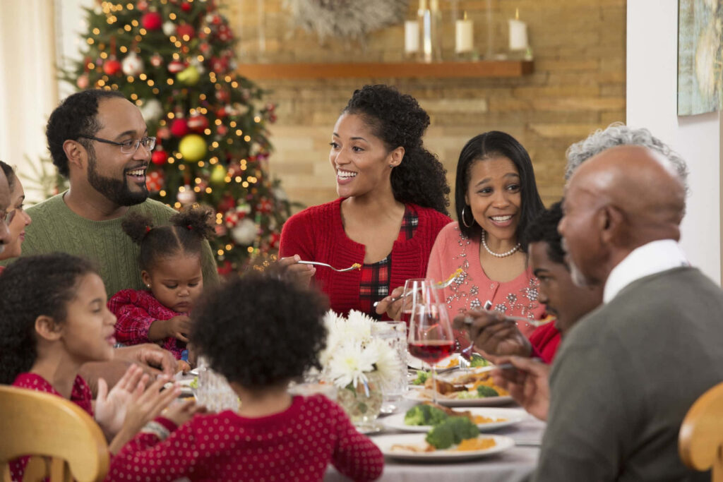 Joyful Family Christmas Dinner: Smiles & Festive Decor Wallpaper