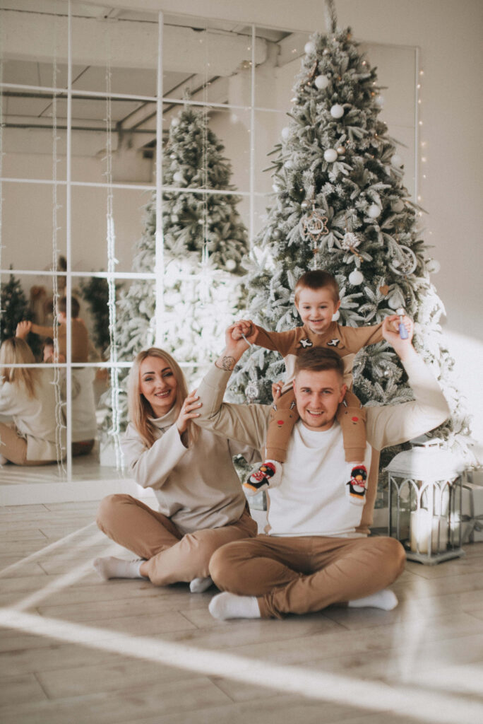 Joyful Family Christmas Celebration with Festive Decor and Tree Wallpaper