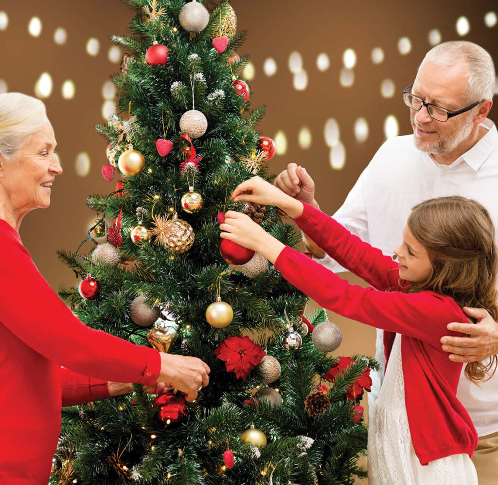 Joyful Family Christmas: Decorating Tree with Red & Gold Ornaments Wallpaper