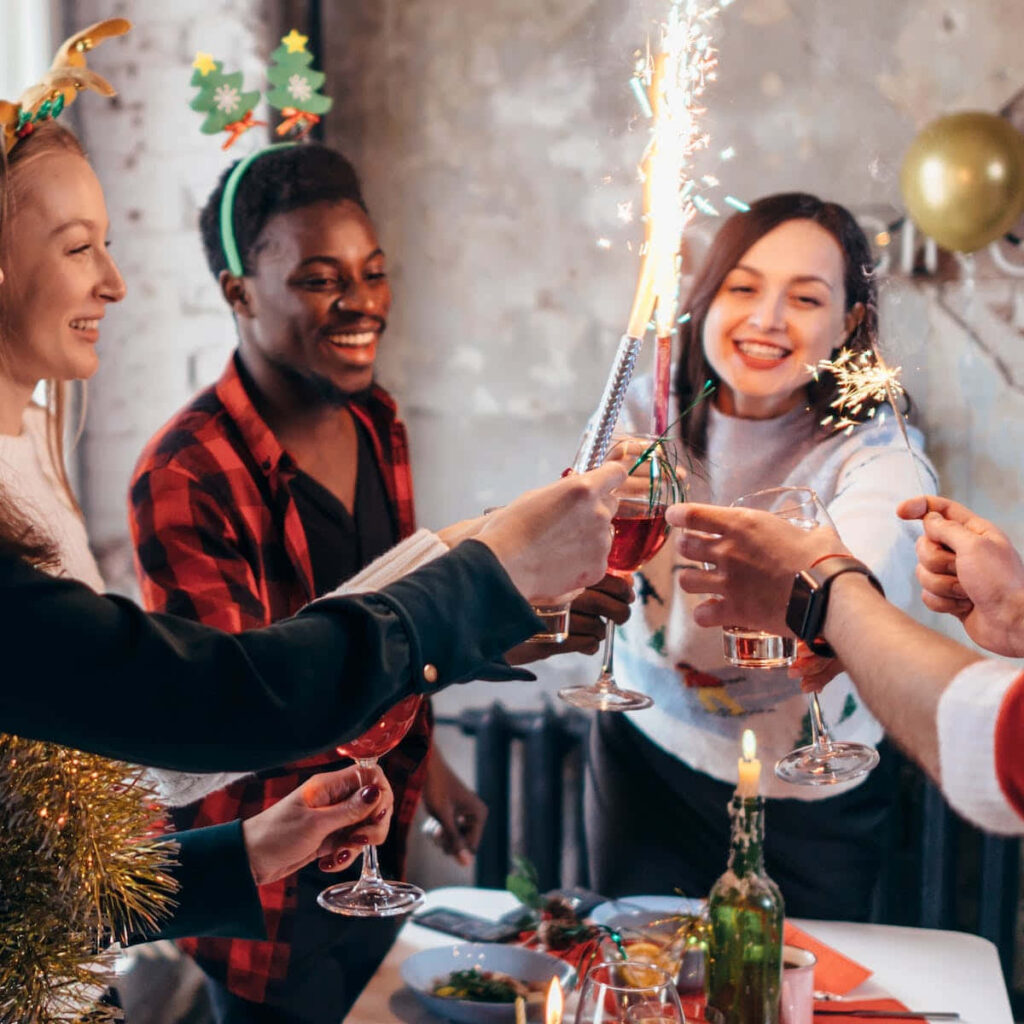Cheers and Sparklers: Friends Celebrate in a Festive Atmosphere Wallpaper