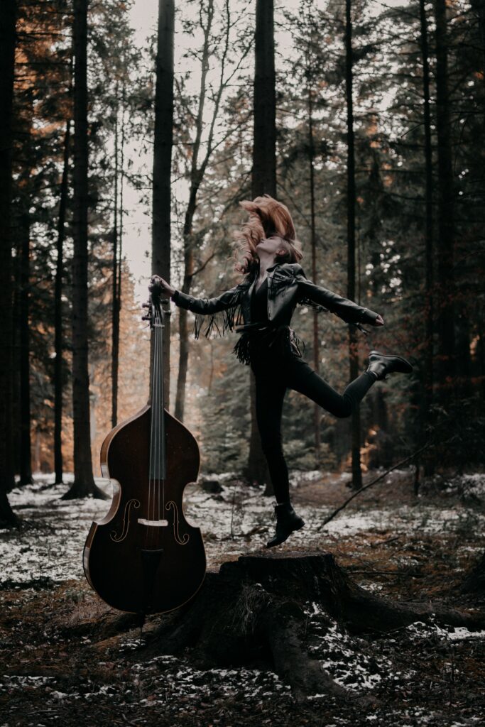 “Joyful Girl & Musical Instrument Wallpaper in Serene Forest”