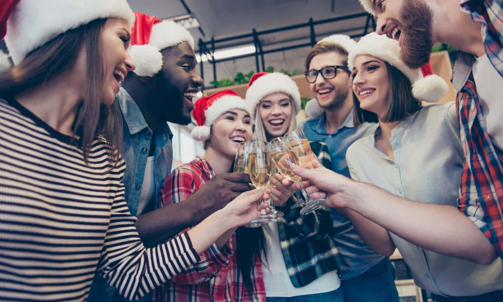 Joyful Friends Celebrating with Holiday Cheer in Festive Wallpaper