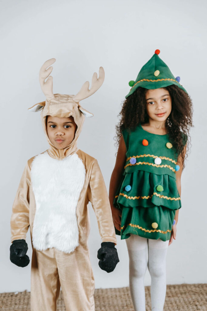 Joyful Christmas Wallpaper: Kids in Reindeer & Tree Costumes