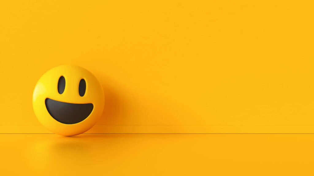 Sunny Smiles: A Vibrant Yellow Ball Wallpaper with a Cute and Cool Smile