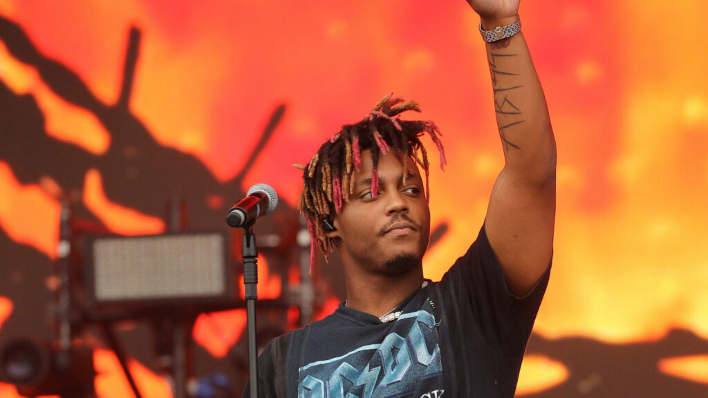 Juice WRLD performing live in black AC DC tee vibrant fiery orange stage background wallpaper