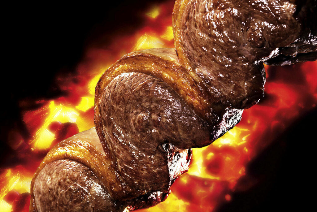 Juicy Churrasco: Sizzling Meat Close-Up Wallpaper for Food Lovers