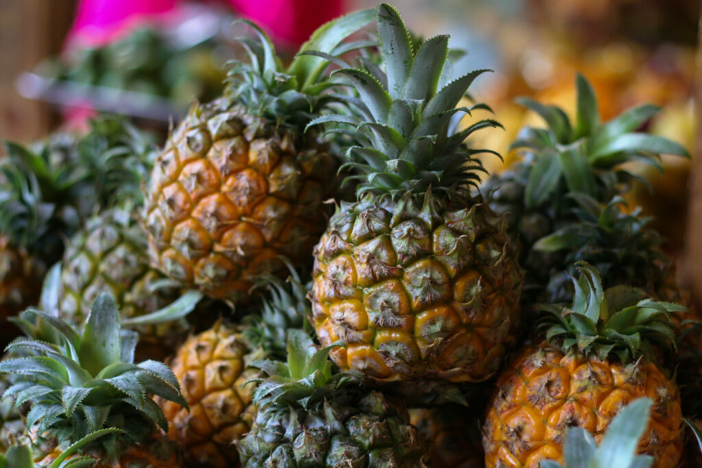 Tempting Tropical Delights: A Vibrant and Juicy Pineapple Paradise Wallpaper