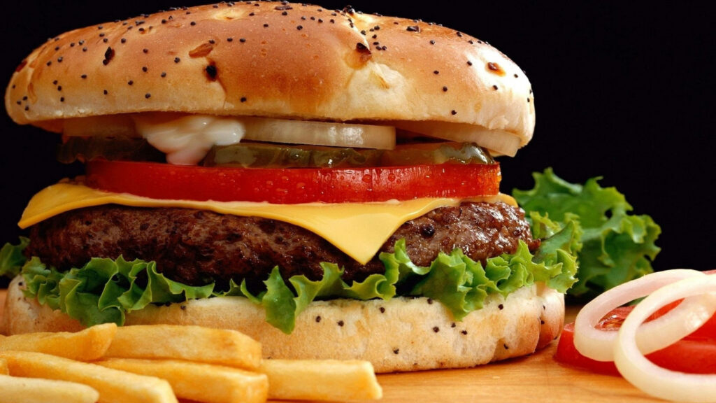 Juicy Quarter-Pound Burger Close-Up with Crispy Fries Wallpaper