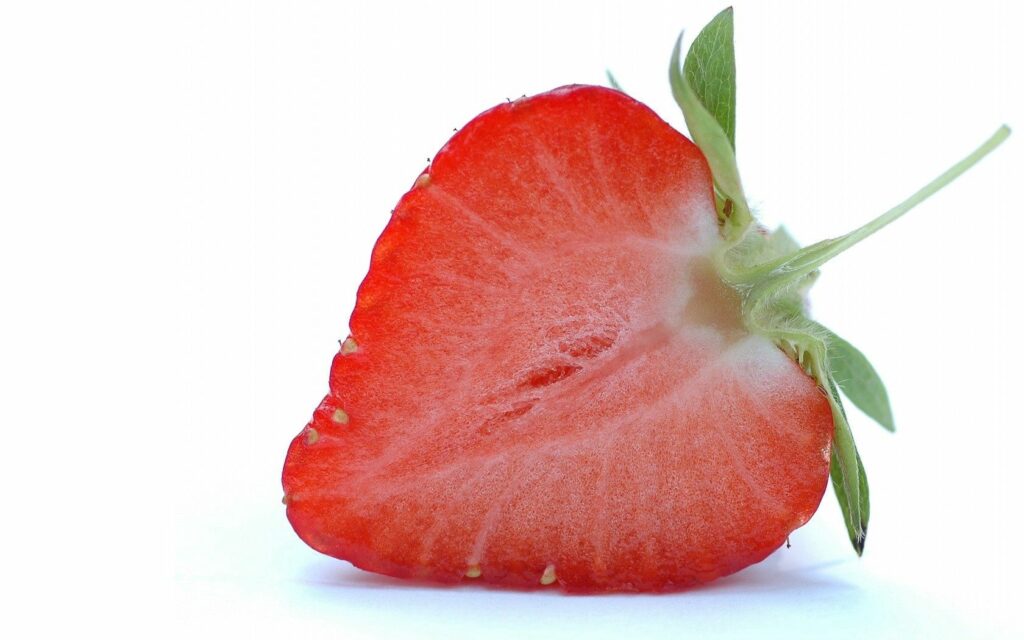 Juicy Strawberry Close-Up Wallpaper: Fresh Red Flesh & Green Leaves