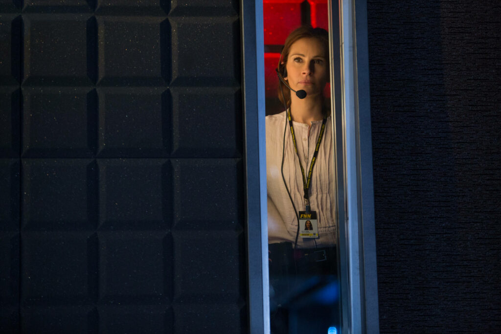 Julia Roberts focused producer wearing headset behind glass in tense Money Monster studio scene wallpaper