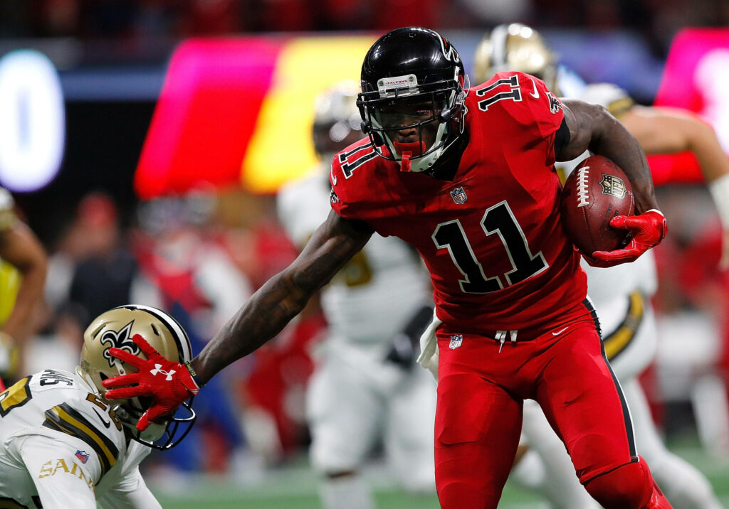 Julio Jones Atlanta Falcons breaking tackles intense football action powerful game moment wallpaper