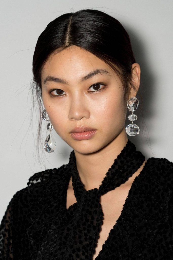 Jung Ho-yeon high fashion portrait with black textured top and crystal drop earrings studio lighting Wallpaper