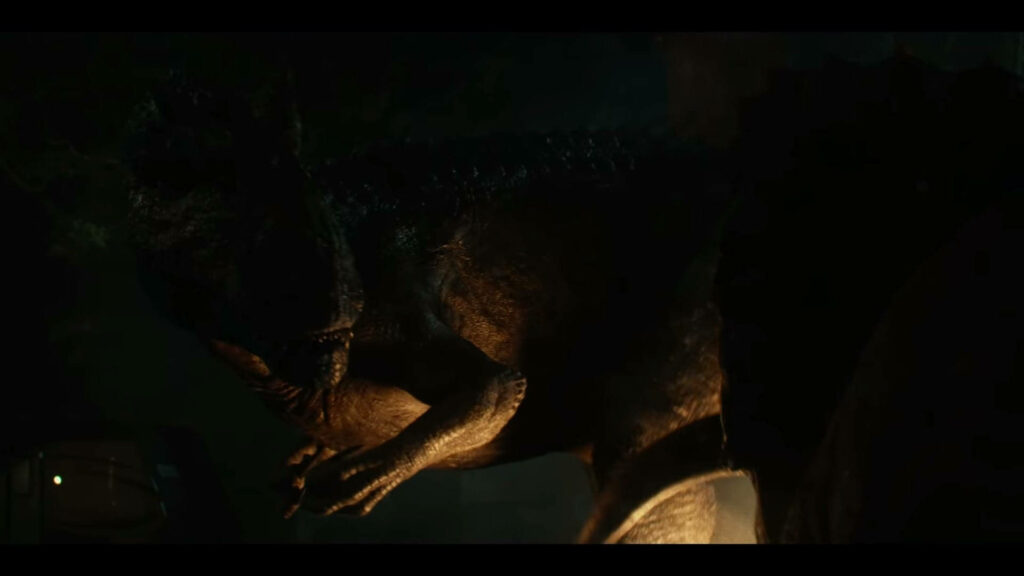 Massive Jurassic World Dominion dinosaur emerging from shadows with detailed scales background Wallpaper