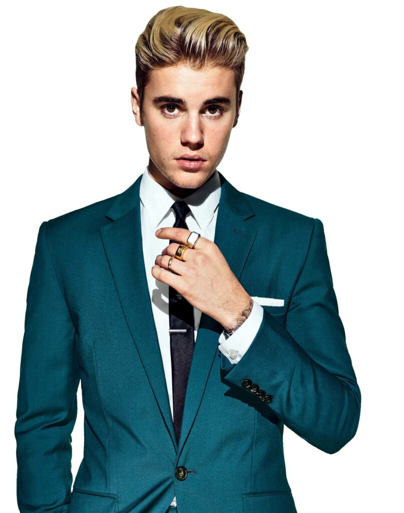 Justin Bieber in a sharp blue suit posing stylishly for a bold fan wallpaper background