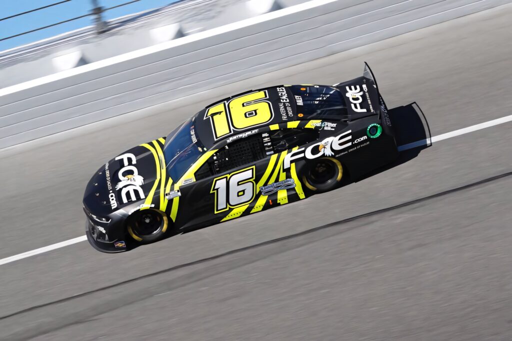 Justin Haley No 16 Chevrolet race car black yellow Foe design speeding on track motorsports wallpaper