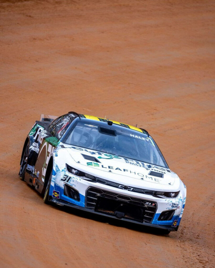Justin Haley race car front view speeding on dirt track showcasing bold design and sponsors Wallpaper
