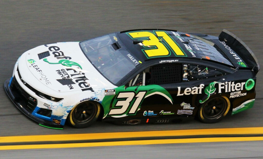 Justin Haley celebrates LeafFilter race car win standing proudly racing victory wallpaper background