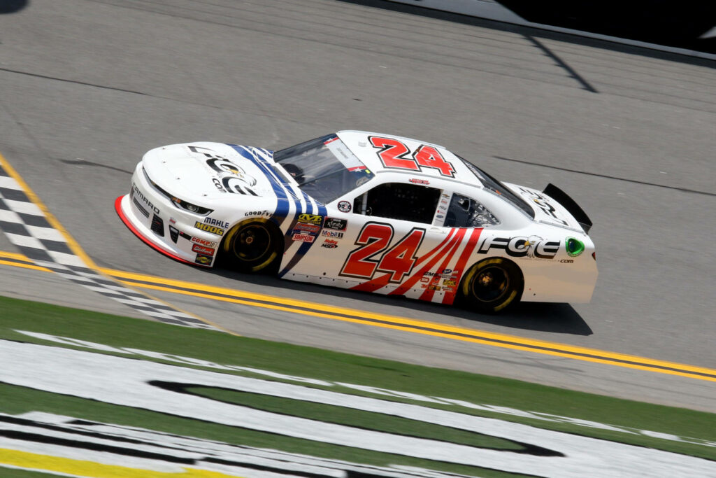 Justin Haley winning Daytona race in number 24 car celebrating thrilling finish line victory wallpaper