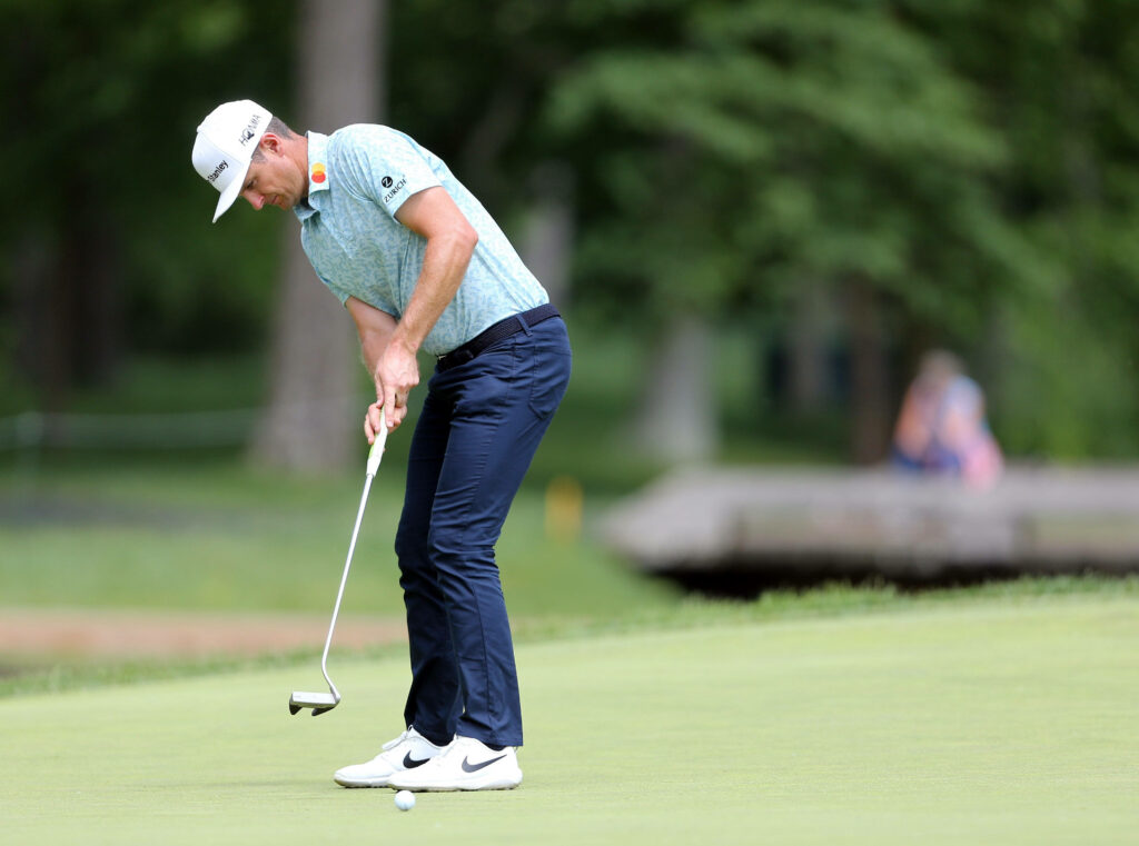 Intense Justin Rose Putt Wallpaper on Lush Green Golf Course
